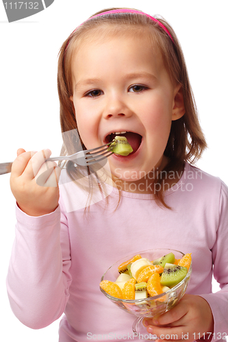 Image of Little girl eats fruit salad
