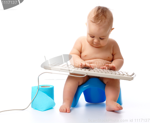 Image of Little child is typing on keyboard
