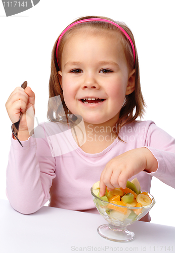 Image of Little girl eats fruit salad