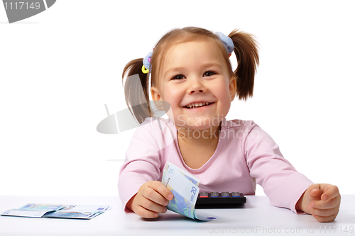 Image of Little girl with few paper euro banknotes