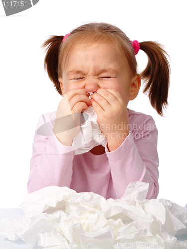 Image of Little girl blows her nose