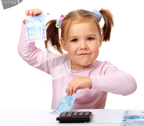 Image of Little girl with few paper euro banknotes