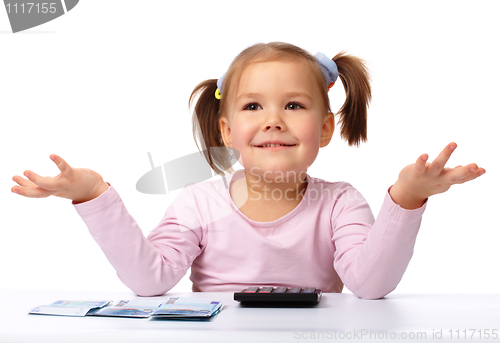 Image of Little girl with few paper euro banknotes