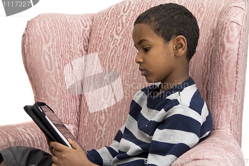 Image of Young boy studying on a tablet PC