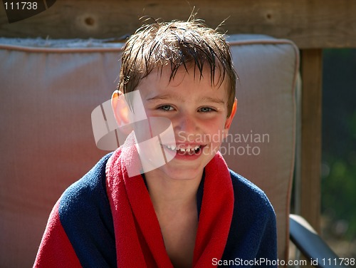 Image of swimming boy wrapped in towel