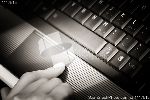 Image of Working at laptop .
