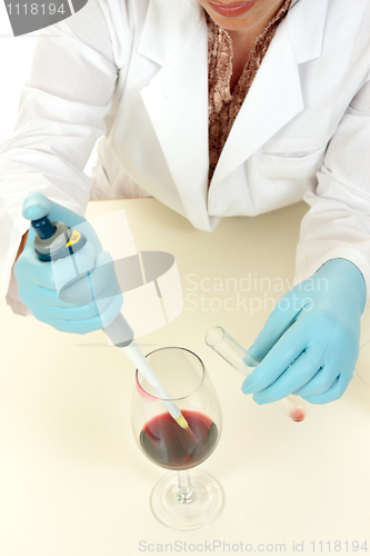 Image of Scientist using pipette to take sample