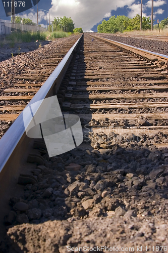 Image of Railroad Tracks with Clouds in the Horizon
