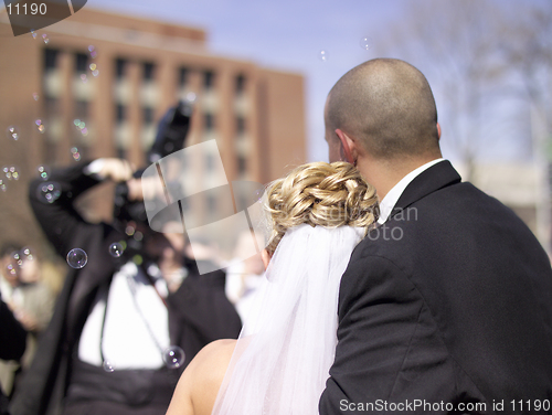 Image of Wedding Couple - A photographer takes a picture of a bride and groom at a real wedding. 14MP camera.