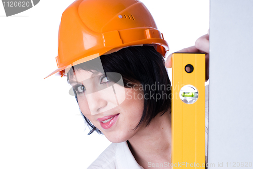 Image of Woman in helmet with level