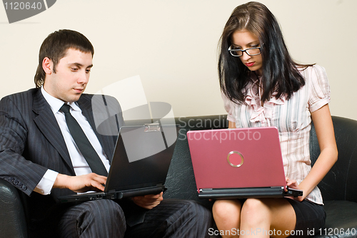 Image of Businessmen with computers on sofa