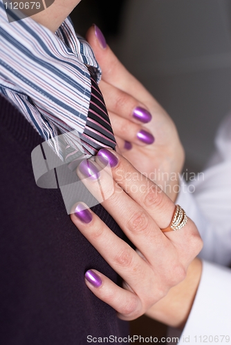 Image of Tie correction on businessman