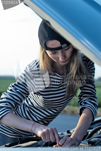 Image of Young Blond Woman With Her Broken Car