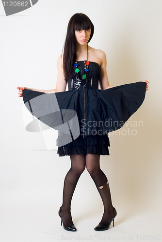 Image of Young woman in torn stockings