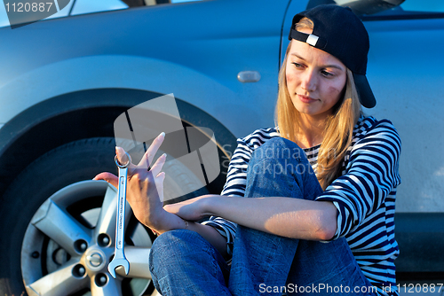 Image of Young Blond Woman With Her Broken Car