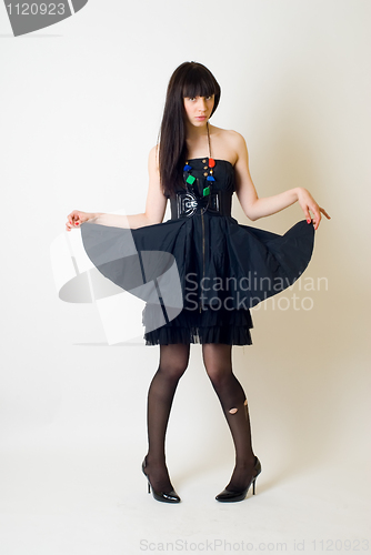 Image of Young woman in torn stockings