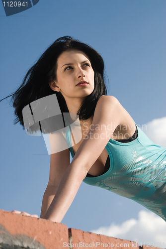 Image of Young woman on roof