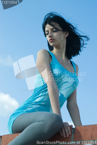 Image of Young woman on roof