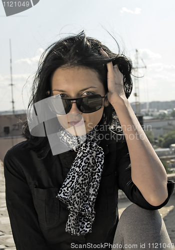 Image of Young woman on roof