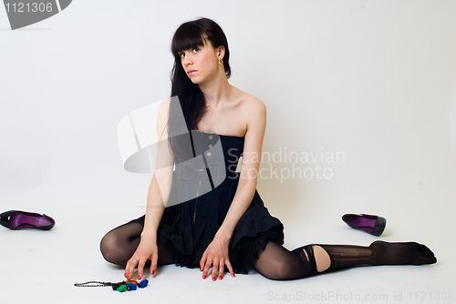 Image of Young woman in torn stockings