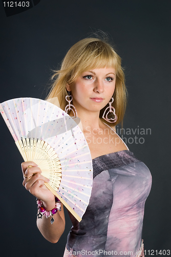 Image of Beautiful young woman with fan