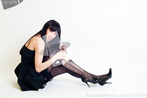 Image of Young woman in torn stockings