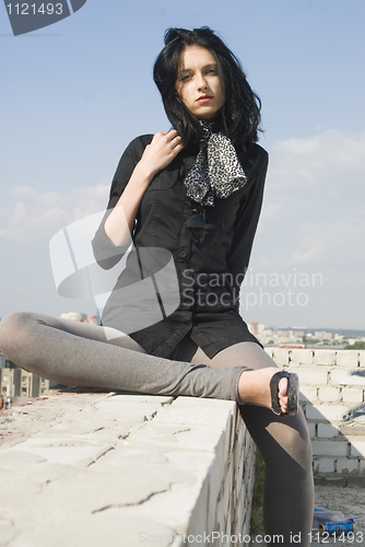 Image of Young woman on roof