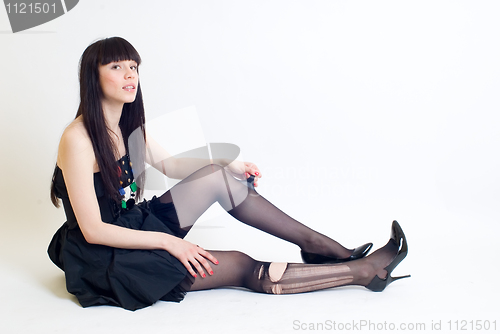 Image of Young woman in torn stockings