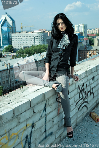 Image of Young woman on roof