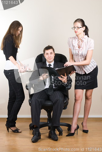 Image of Businessman with assistants