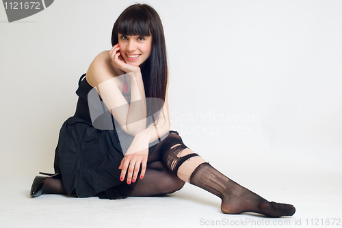 Image of Young woman in torn stockings