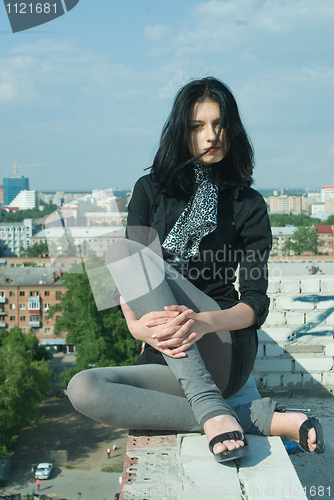 Image of Young woman on roof