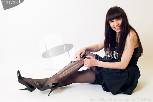 Image of Young woman in torn stockings