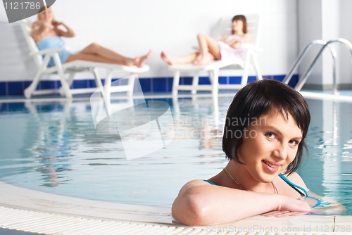 Image of Young woman near pool