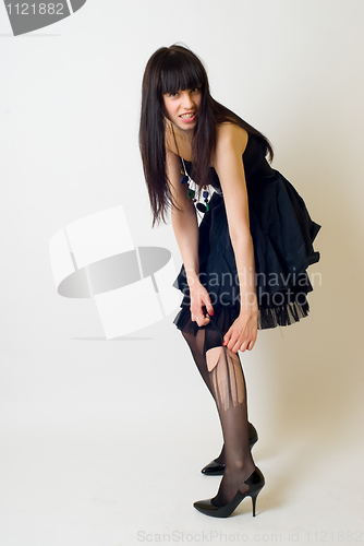 Image of Young woman in torn stockings
