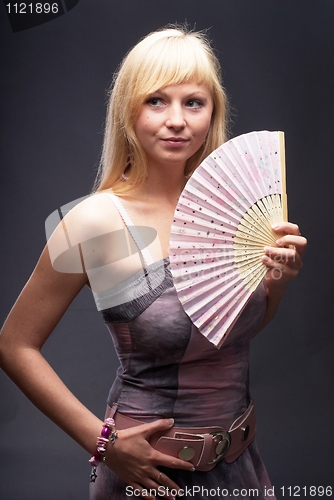 Image of Beautiful young woman with fan