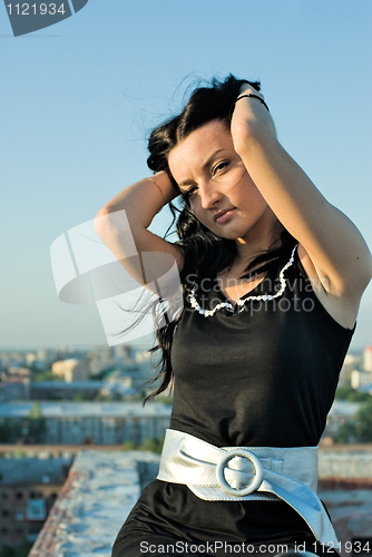 Image of Standing girl on roof