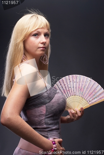 Image of Beautiful young woman with fan