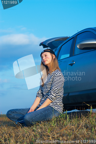 Image of Young Blond Woman With Her Broken Car