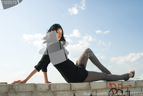 Image of Young woman on roof