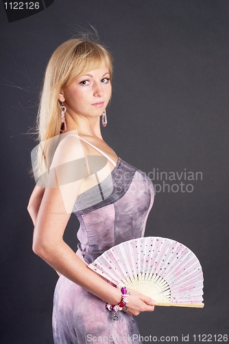 Image of Beautiful young woman with fan