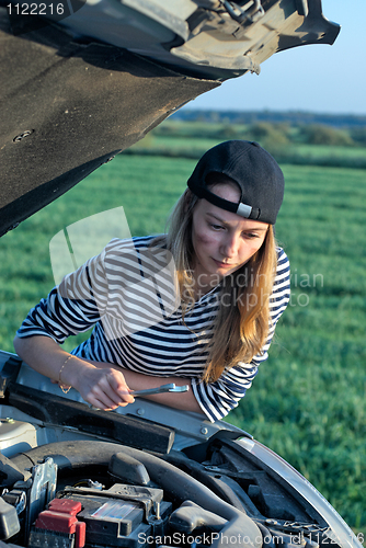 Image of Young Blond Woman With Her Broken Car