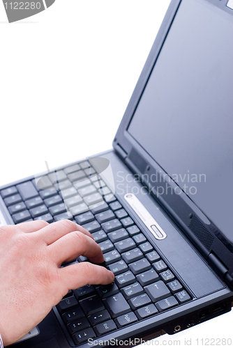 Image of Male hand typing on a laptop