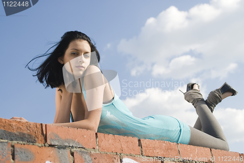 Image of Young woman on roof