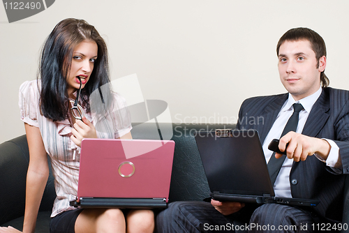 Image of Businessmen with computers on sofa