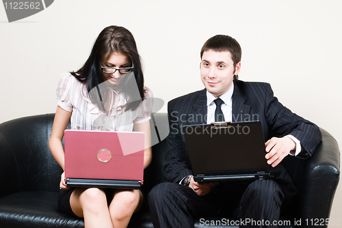 Image of Businessmen with computers on sofa
