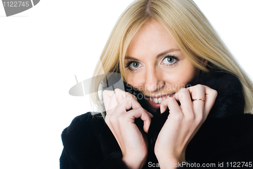 Image of Young woman in fur coat