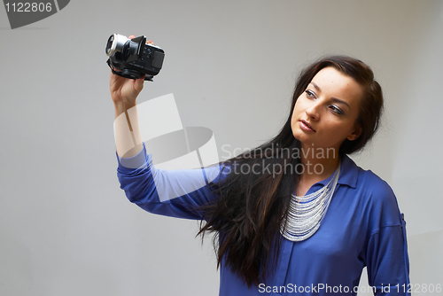 Image of Young woman with camera