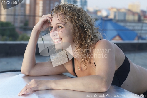 Image of Young woman on roof