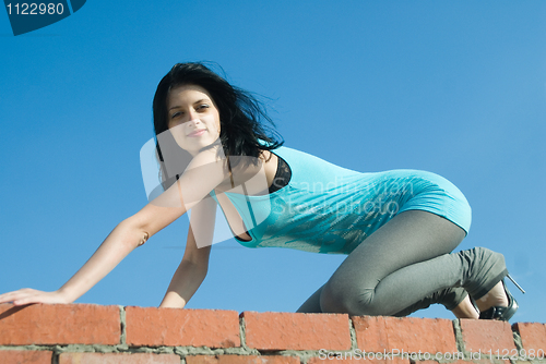 Image of Young woman on roof